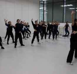 A group of GCSE students in a studio with dance artist at the front.